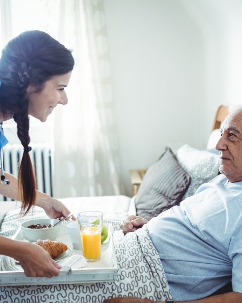 nurse-serving-breakfast-to-senior-man.jpg